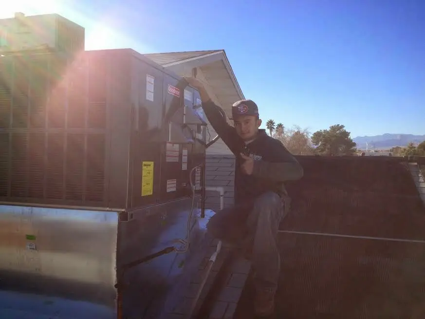 HVAC technician performing Air Duct Repair on a rooftop unit in Lake Forest